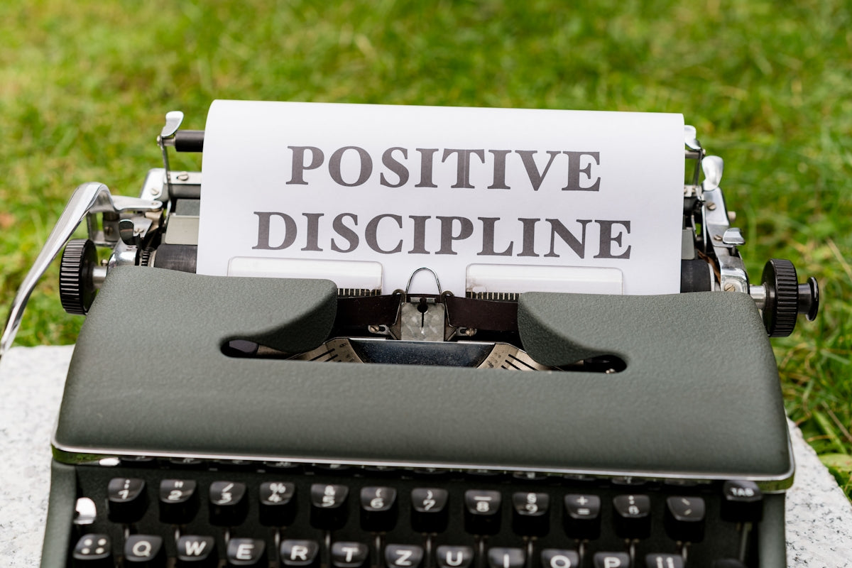 a close up of a typewriter with a paper that says positive, disc